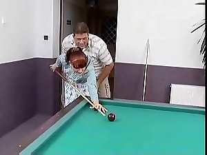 Red haired german solid screwed on a pool table